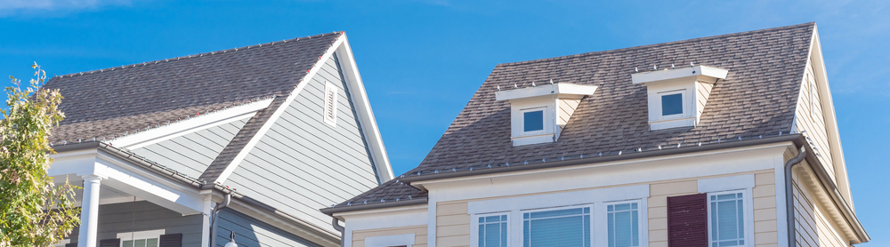 Shingle roof on yellow house