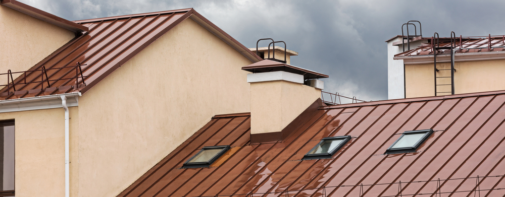 Tan house with brown metal roofing