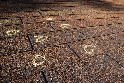 Hail damage shown on a roof