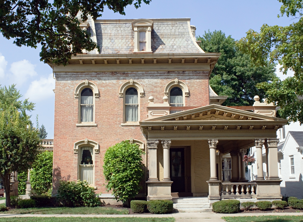 a brick home with a Mansard roof