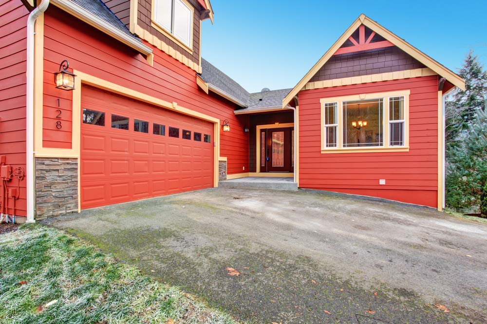 a home with red siding and red garage doors