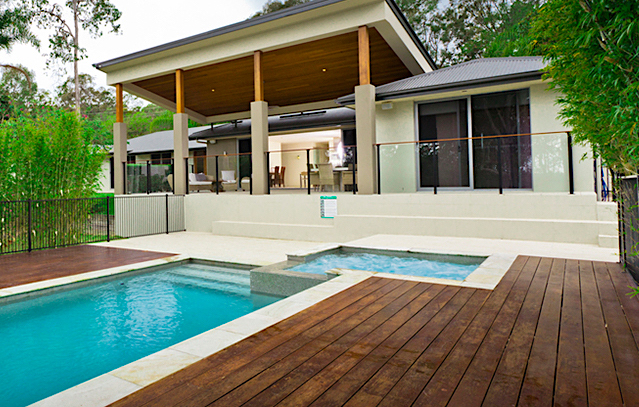 deck surrounding a swimming pool and hot tub