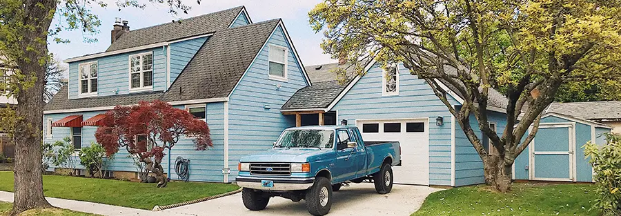 home with grey roof and blue siding