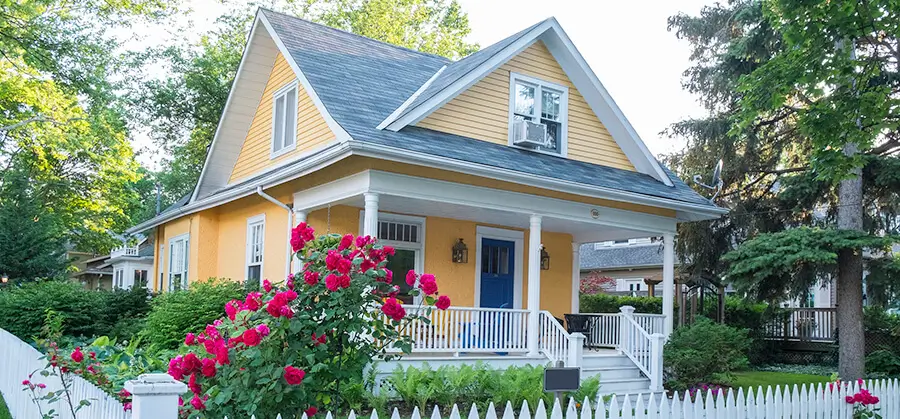 bright yellow house with gray shingles