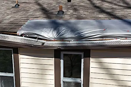 Roof damage in need of repair on a home in Oak Ridge