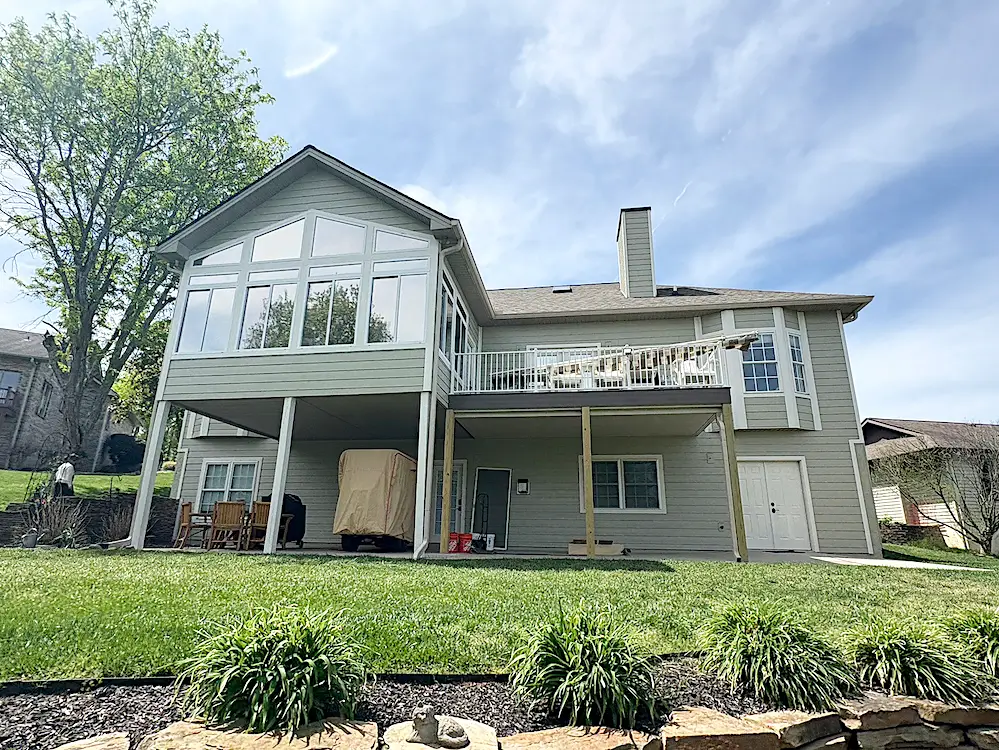 Completed rear view of Tellico Village home with Svelte Sage James Hardie siding and white trim.