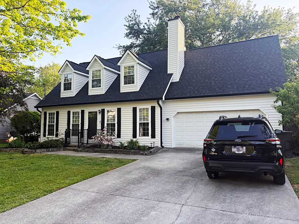 Cape Cod home with new black TAMKO roof and white Mastic siding in Cedar Bluff West Knoxville TN